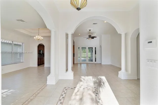 an empty room with a ceiling fan and a bathroom