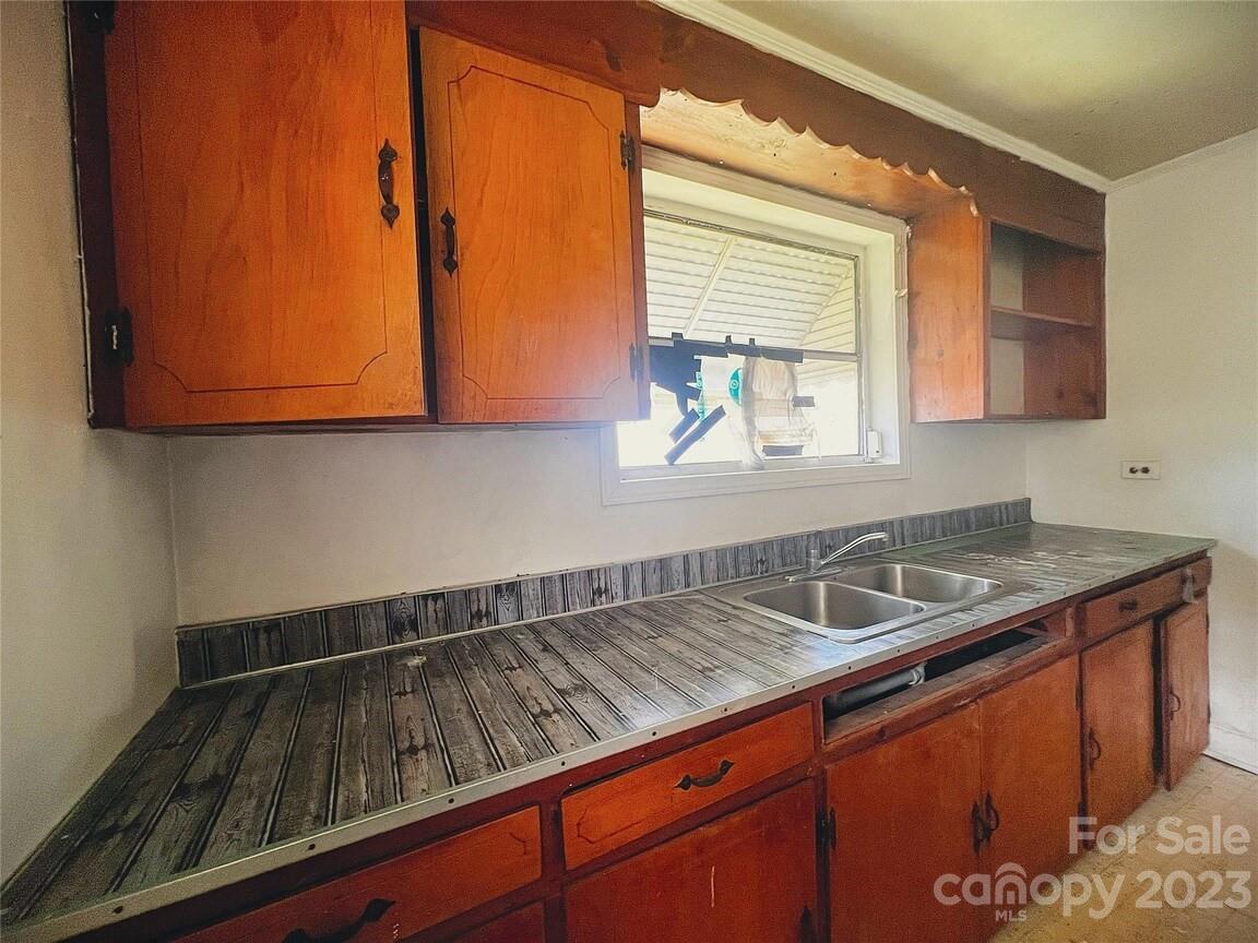 22 Broad Street Great Falls, SC 29055 - Photo 3 of 8 a kitchen with sink a window and cabinets