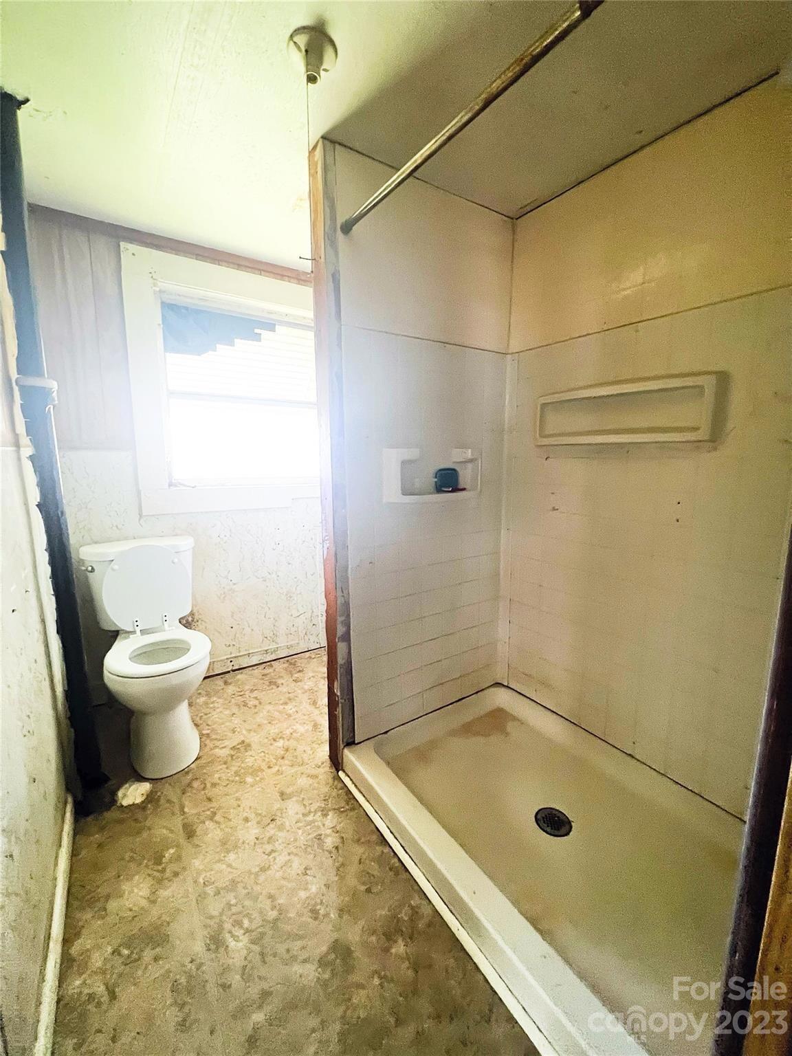22 Broad Street Great Falls, SC 29055 - Photo 7 of 8 a bathroom with a granite countertop bathtub shower and a toilet
