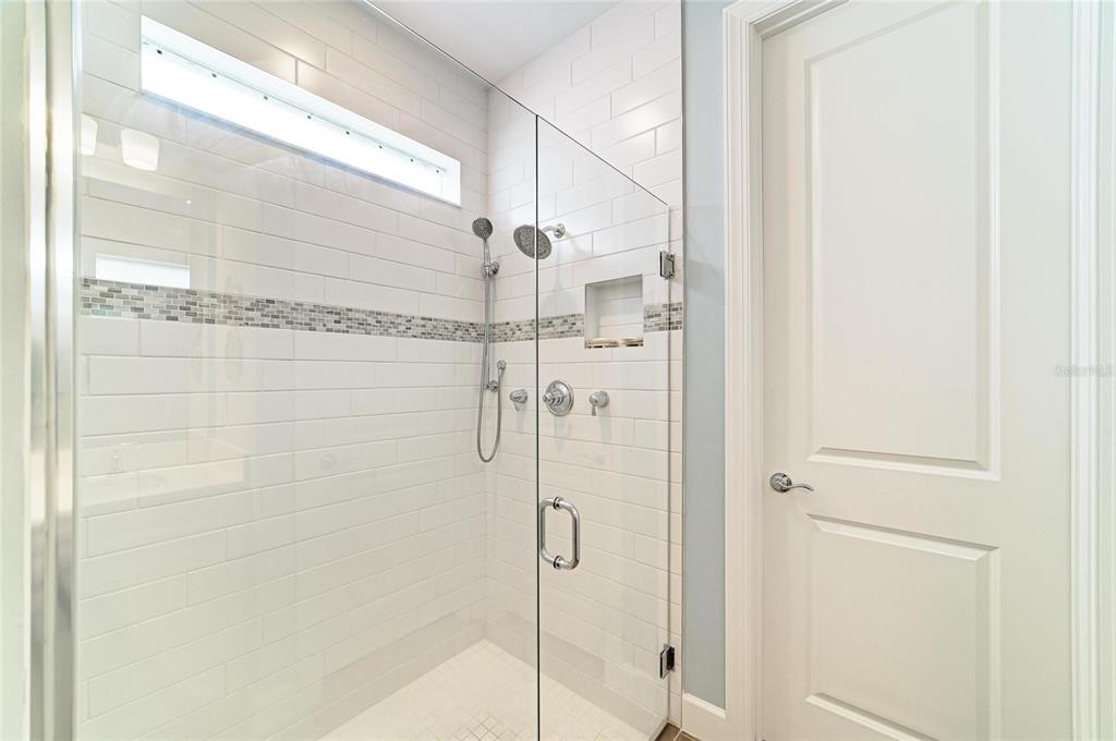 16341 Hidden Oak Loop Lakewood Ranch, FL 34211 - Photo 28 of 76 a bathroom with a glass shower door