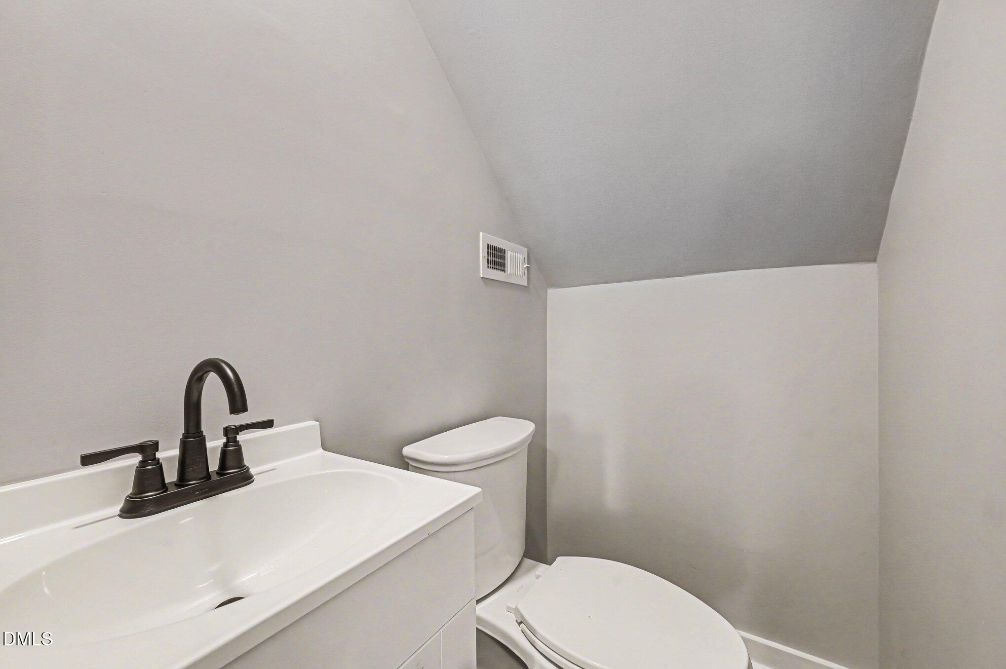 1325 Charlie Carr Road Roxboro, NC 27574 - Photo 17 of 31 a bathroom with a toilet sink and a mirror