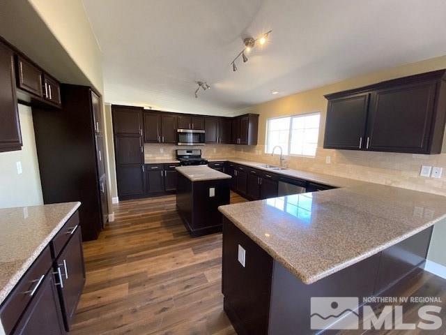 18020 Hazelnut Drive Reno, NV 89508 - Photo 18 of 19 a kitchen with granite countertop a sink a counter top space and stainless steel appliances