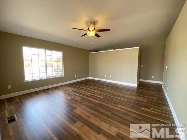 18020 Hazelnut Drive Reno, NV 89508 - Photo 2 of 19 an empty room with wooden floor chandelier fan and windows