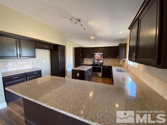 18020 Hazelnut Drive Reno, NV 89508 - Photo 5 of 19 a kitchen with stainless steel appliances granite countertop a sink a stove and a refrigerator