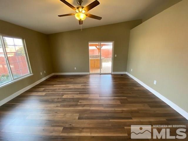 18020 Hazelnut Drive Reno, NV 89508 - Photo 6 of 19 a view of an empty room with wooden floor and a window