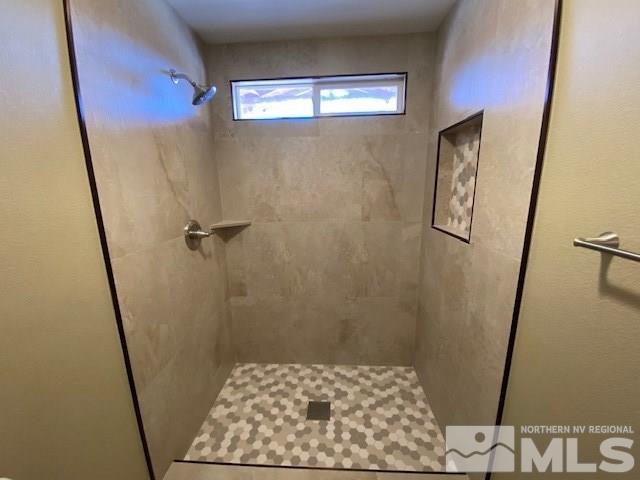 18020 Hazelnut Drive Reno, NV 89508 - Photo 9 of 19 a bathroom with a sink a toilet a mirror and shower