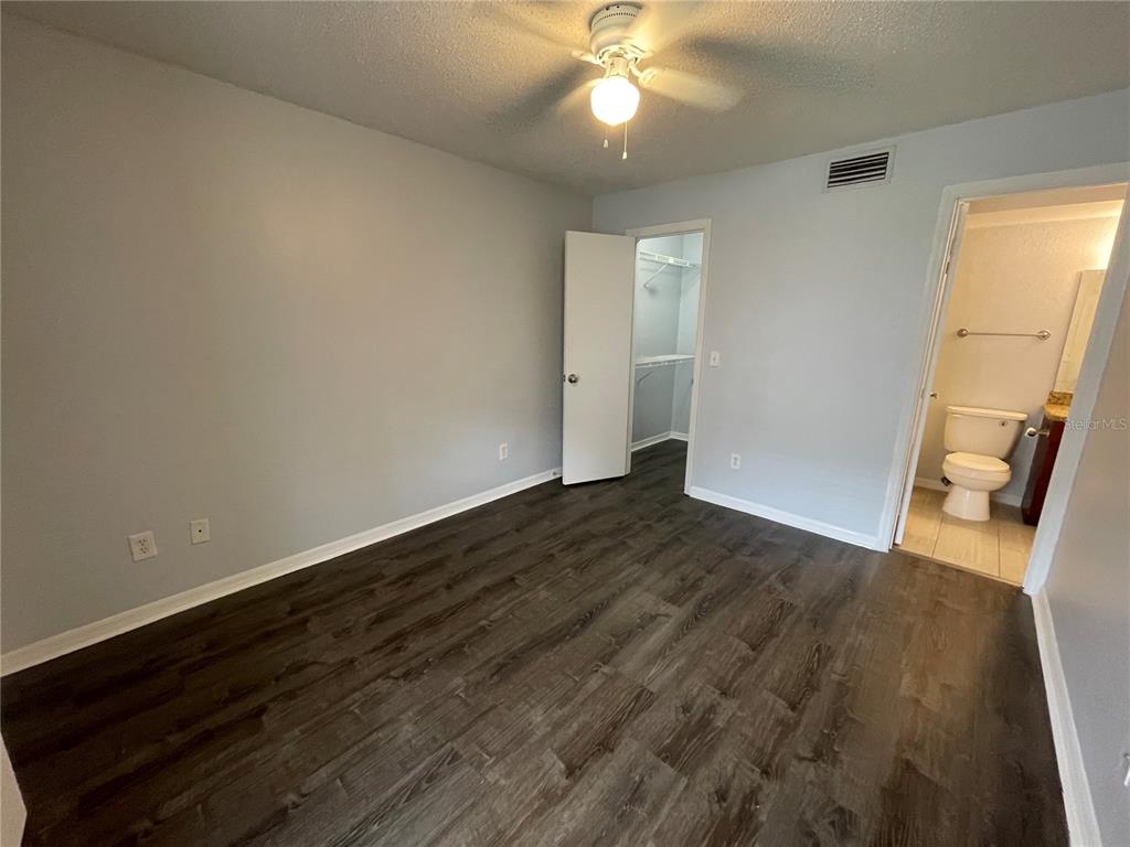 5128 Conroy Road, Unit 13 Orlando, FL 32811 - Photo 13 of 25 wooden floor in an empty room with a window