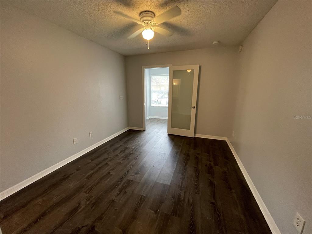 5128 Conroy Road, Unit 13 Orlando, FL 32811 - Photo 15 of 25 wooden floor in an empty room
