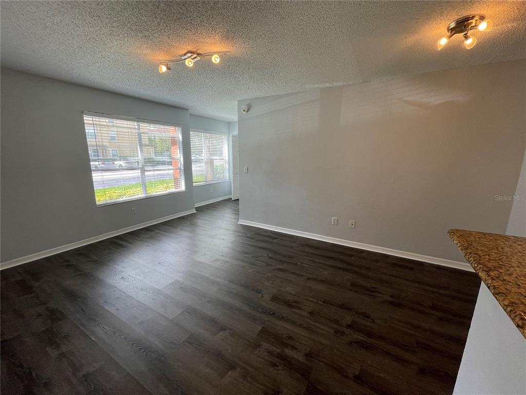 5128 Conroy Road, Unit 13 Orlando, FL 32811 - Photo 9 of 25 an empty room with wooden floor and windows