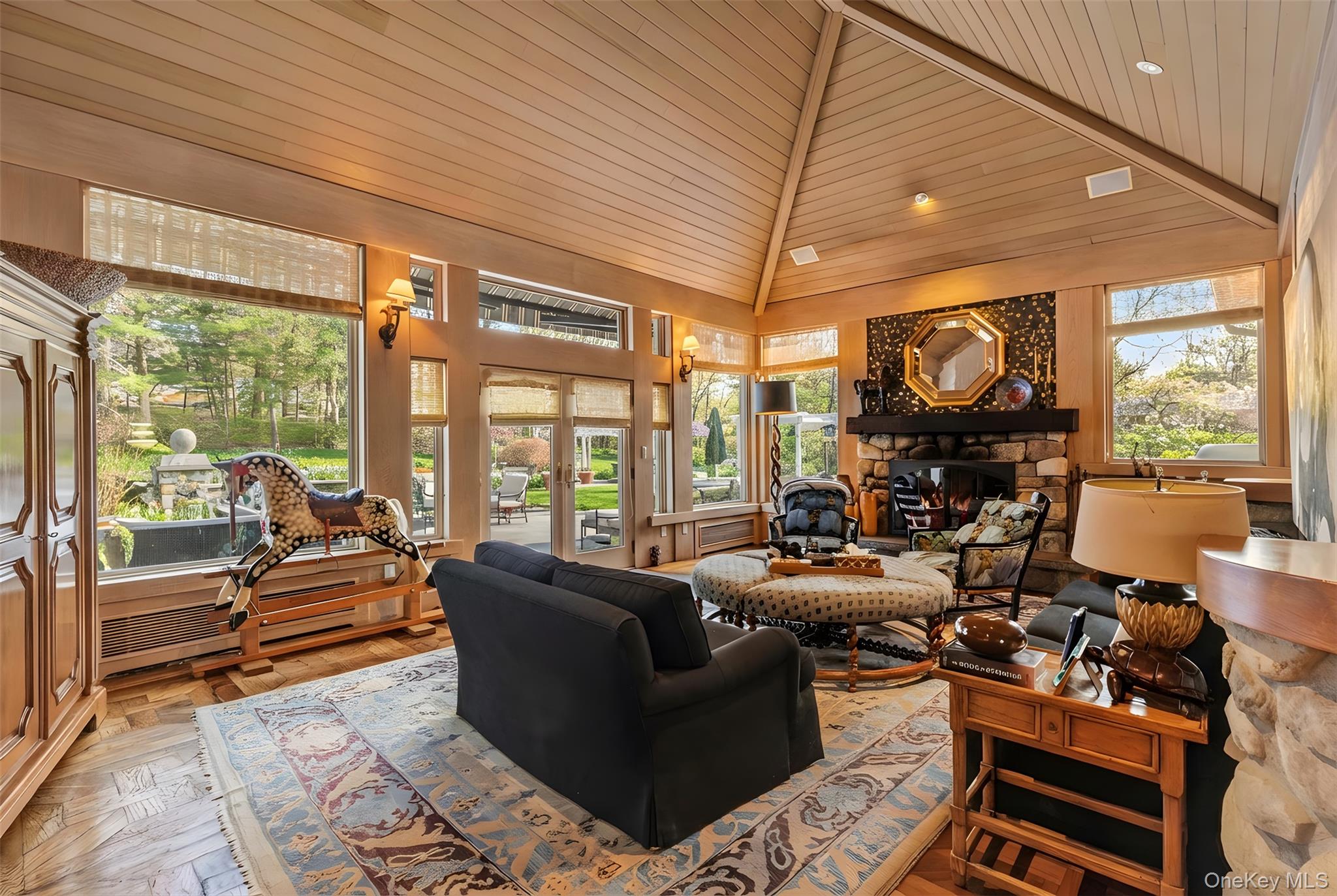 150 Old Farm Road North Chappaqua, NY 10514 - Photo 17 of 44 a living room with furniture a fireplace and large windows