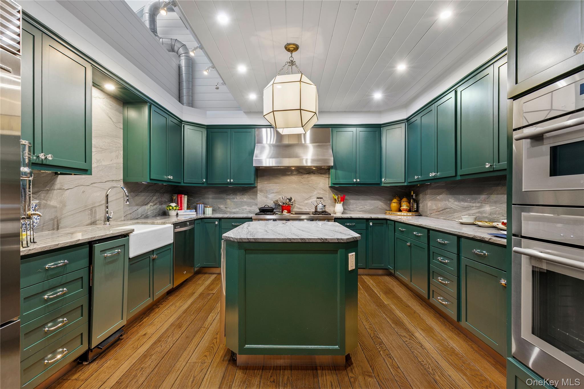 150 Old Farm Road North Chappaqua, NY 10514 - Photo 21 of 44 a kitchen with kitchen island granite countertop a sink stainless steel appliances and cabinets