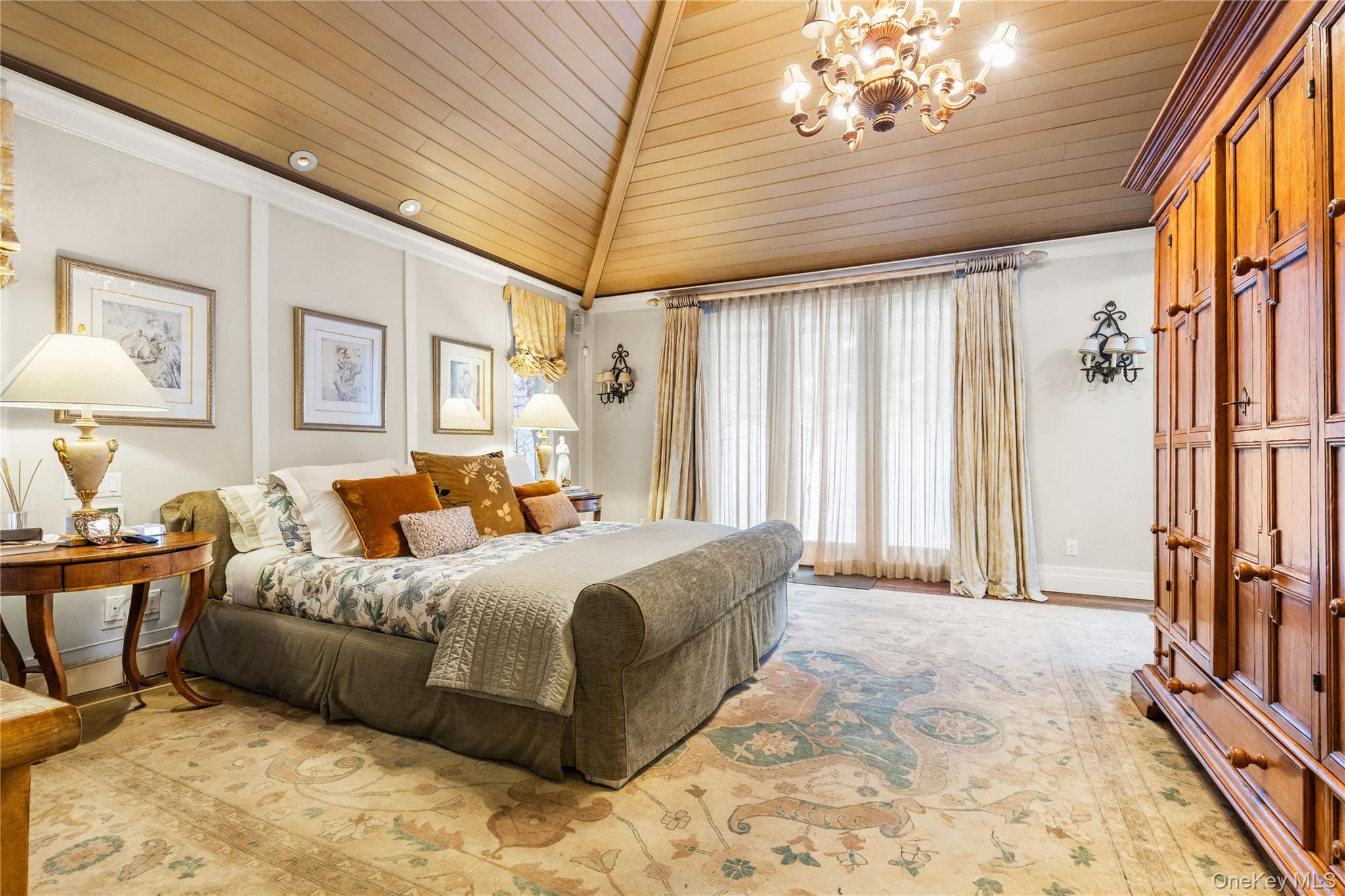 150 Old Farm Road North Chappaqua, NY 10514 - Photo 23 of 44 a spacious bedroom with a large bed and a chandelier
