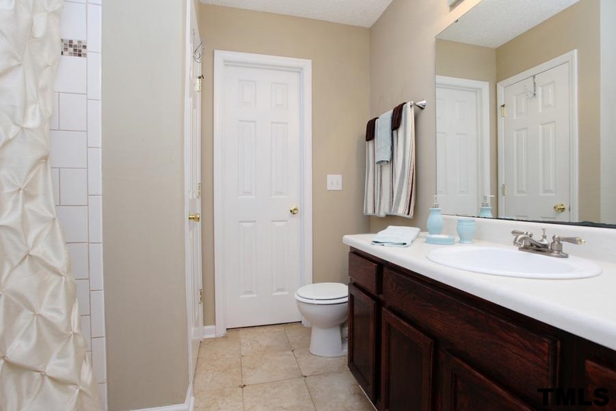 5416 Golden Moss Trail Raleigh, NC 27613 - Photo 13 of 25 Stylish Tiled Shower and Floor add Modern Updating! Plenty of Dressing Space too!