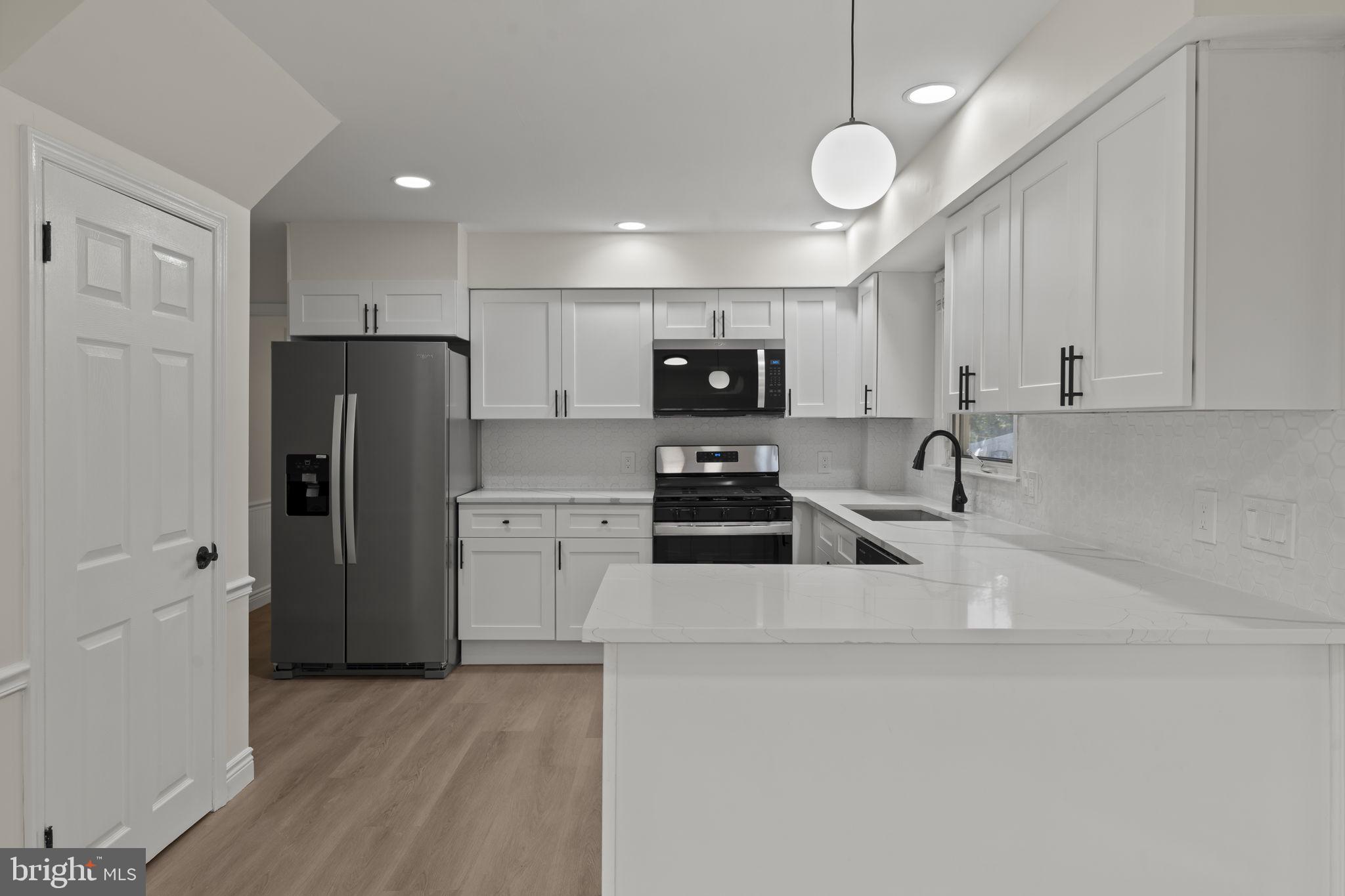 220 Glendale Road Havertown, PA 19083 - Photo 12 of 29 a kitchen with stainless steel appliances a refrigerator stove microwave and cabinets