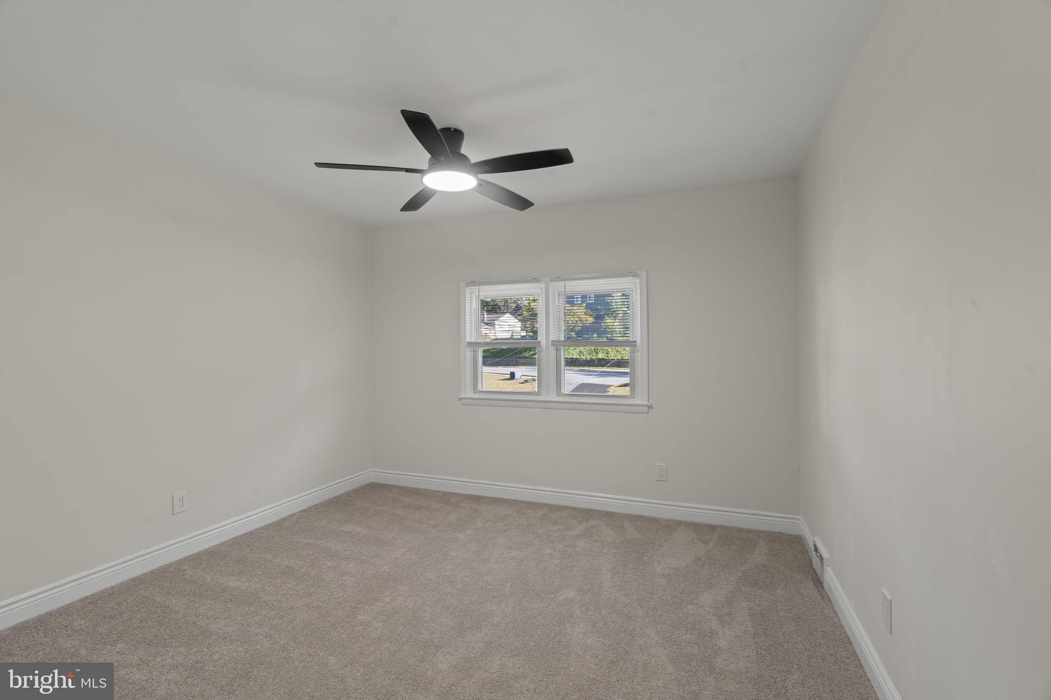 220 Glendale Road Havertown, PA 19083 - Photo 16 of 29 an empty room with a window and ceiling fan