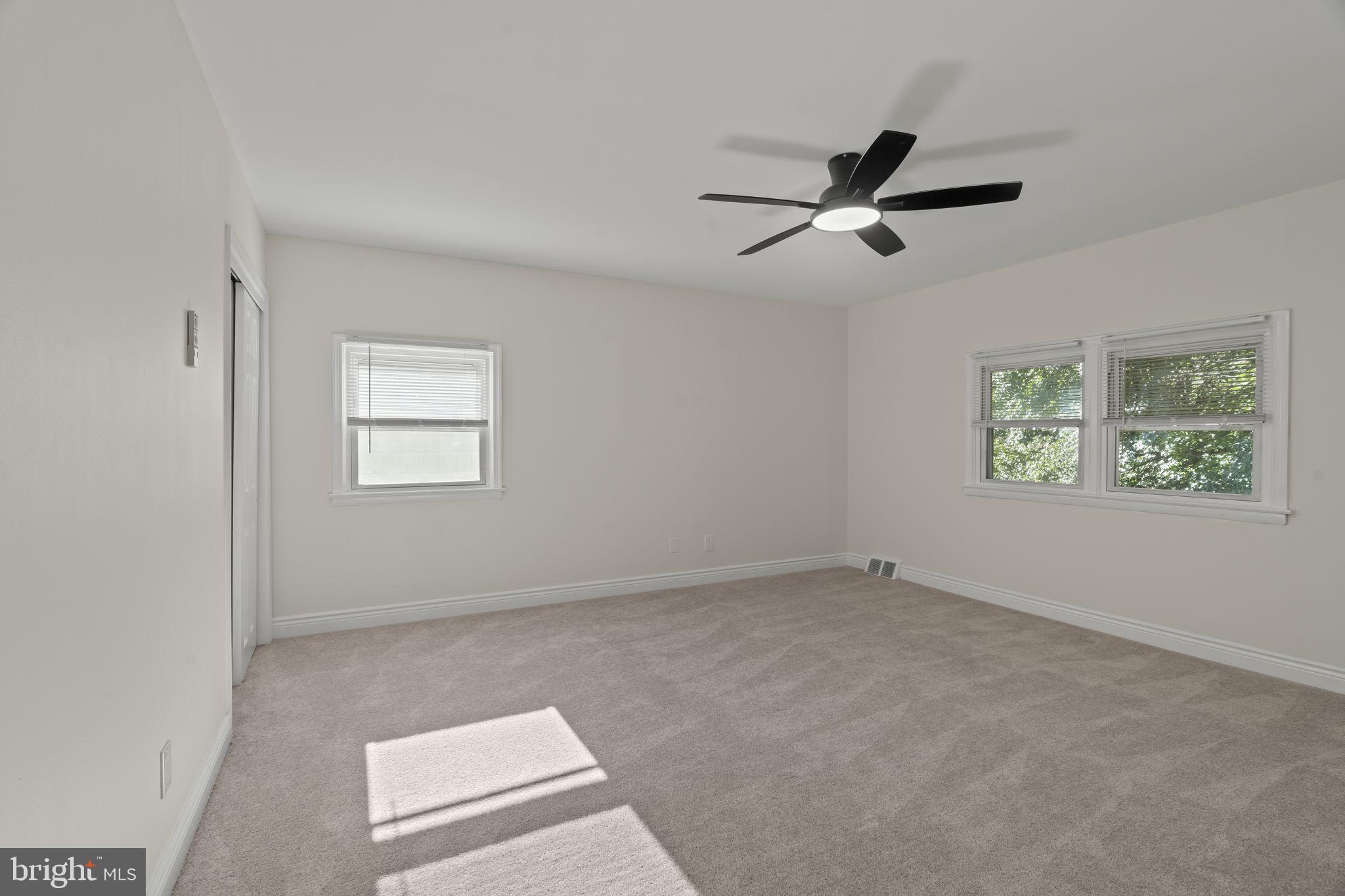 220 Glendale Road Havertown, PA 19083 - Photo 18 of 29 an empty room with windows and ceiling fan