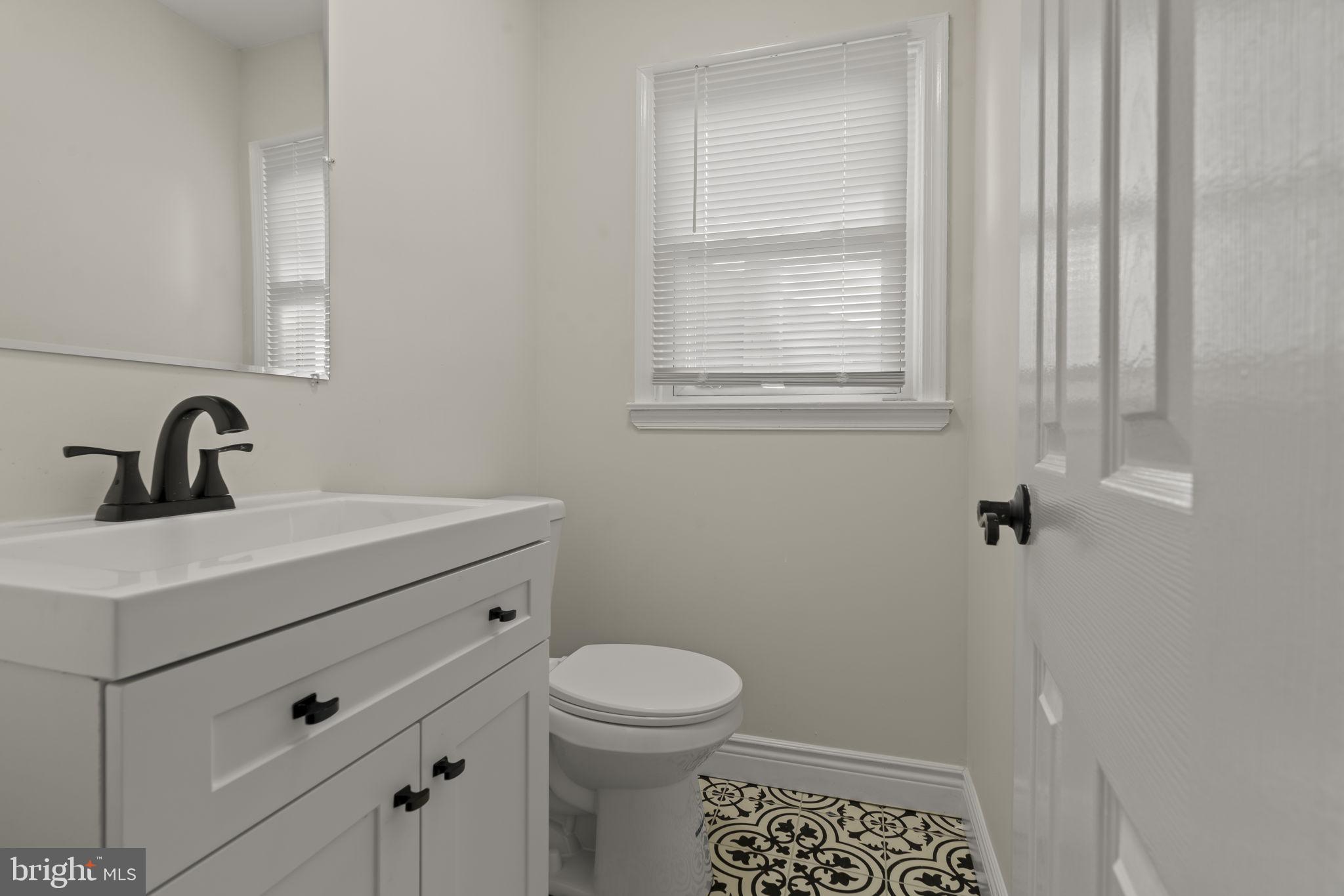 220 Glendale Road Havertown, PA 19083 - Photo 22 of 29 a bathroom with a sink toilet and a window
