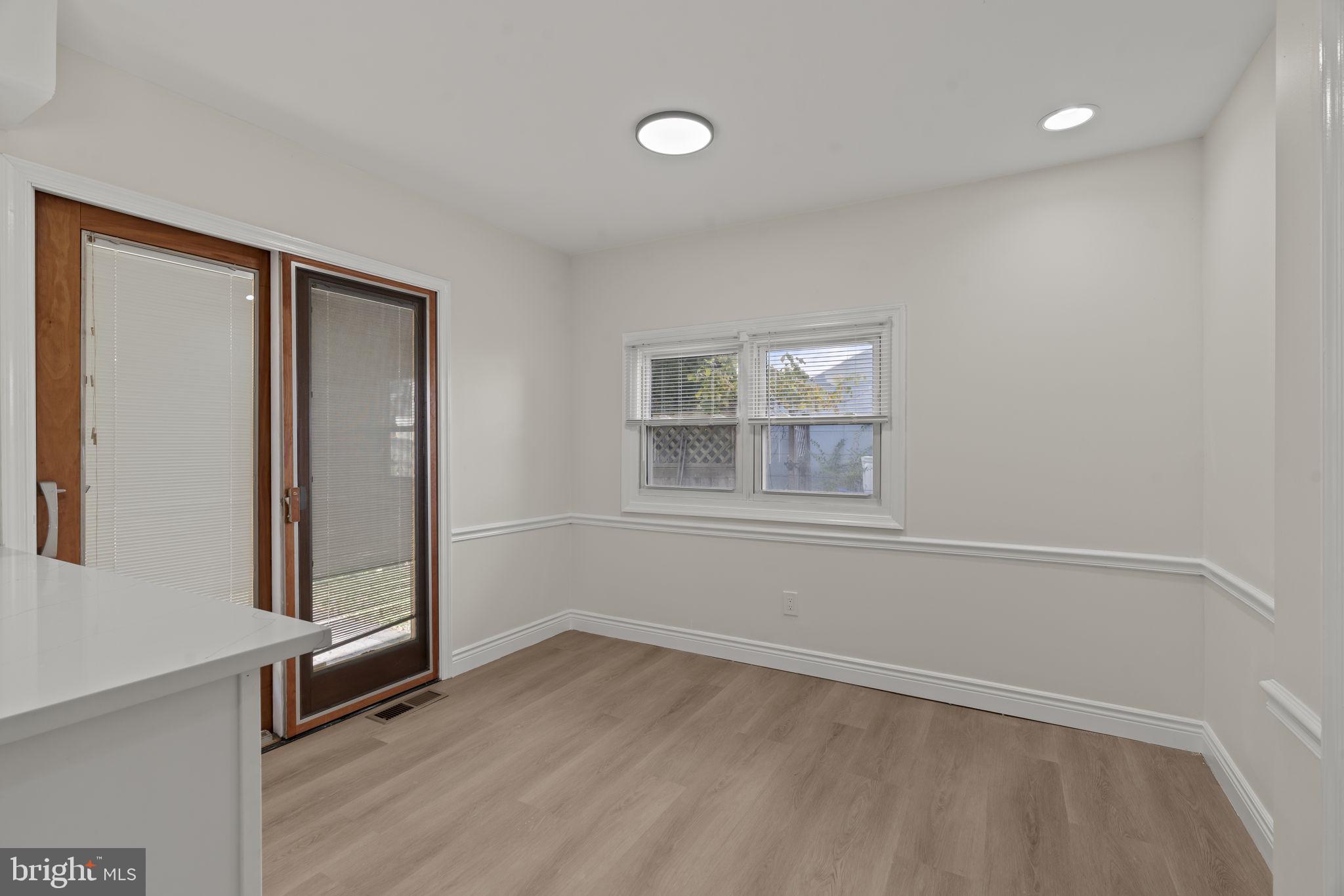 220 Glendale Road Havertown, PA 19083 - Photo 25 of 29 an empty room with wooden floor and windows