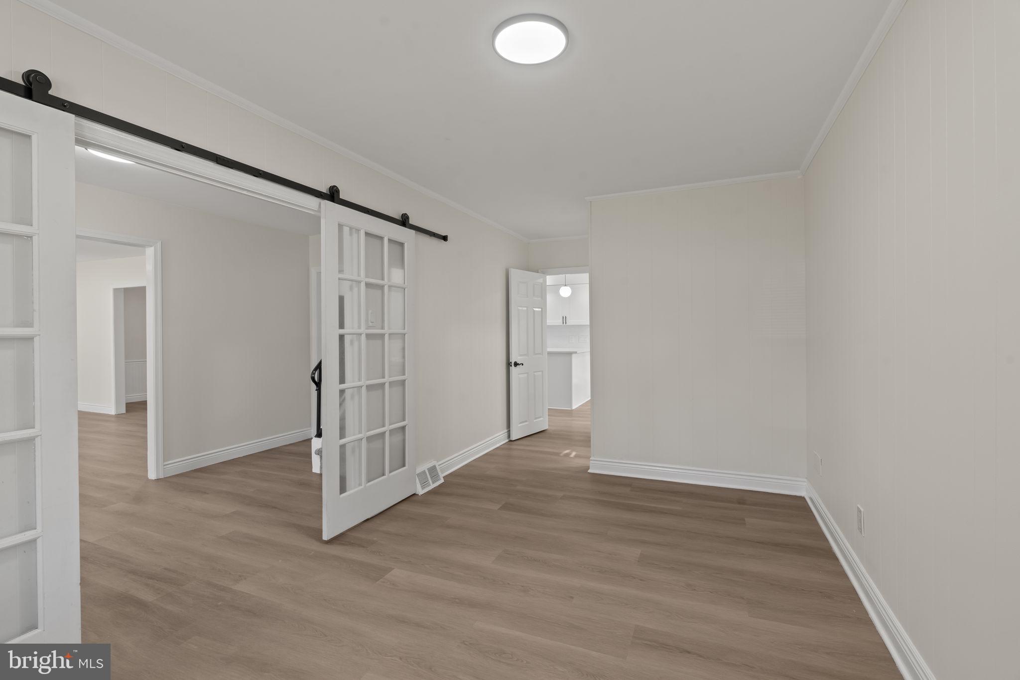 220 Glendale Road Havertown, PA 19083 - Photo 8 of 29 an empty room with wooden floor and windows