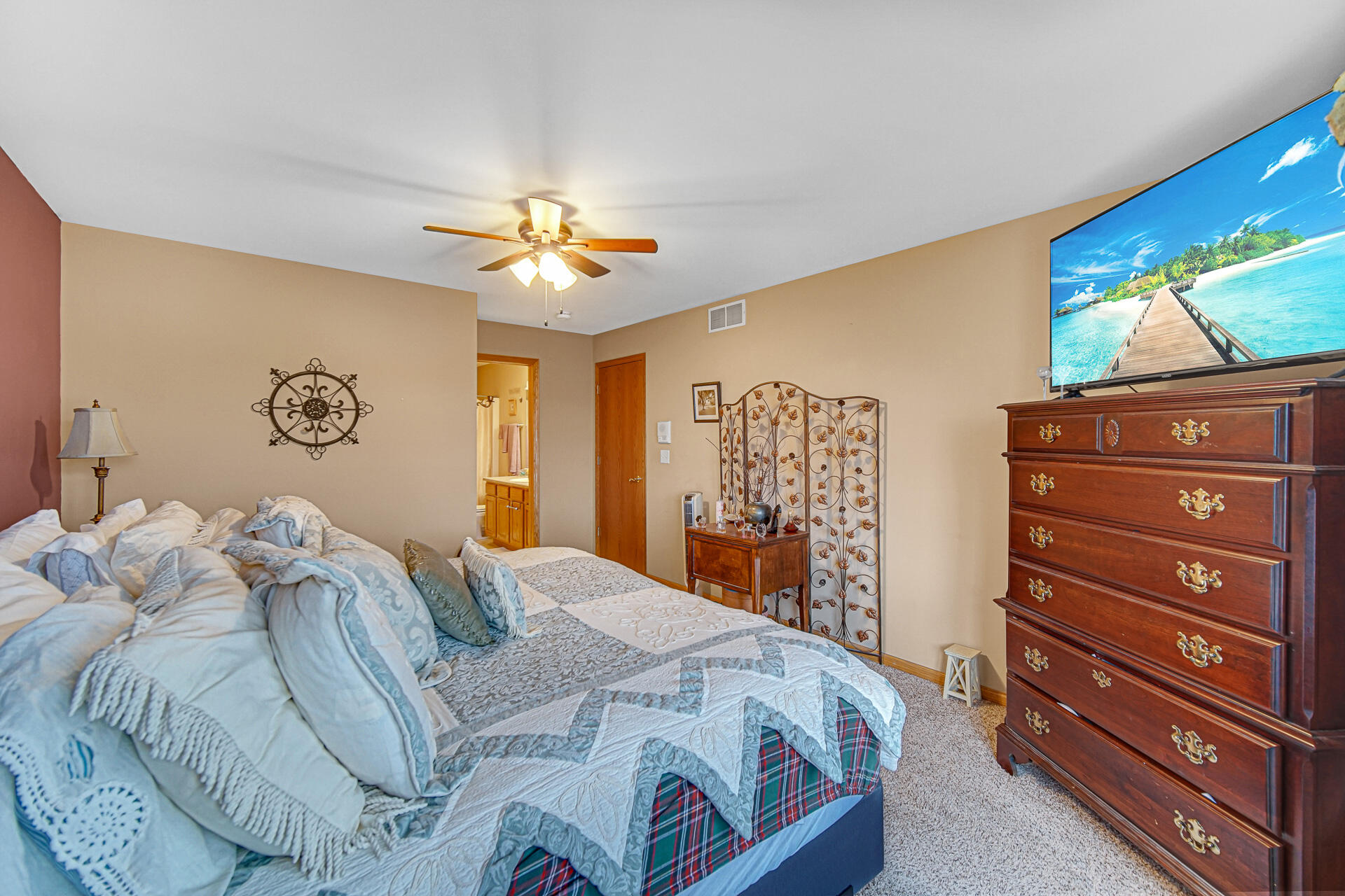 947 Oak Drive Crown Point, IN 46307 - Photo 14 of 23 a bedroom with a bed and a chandelier