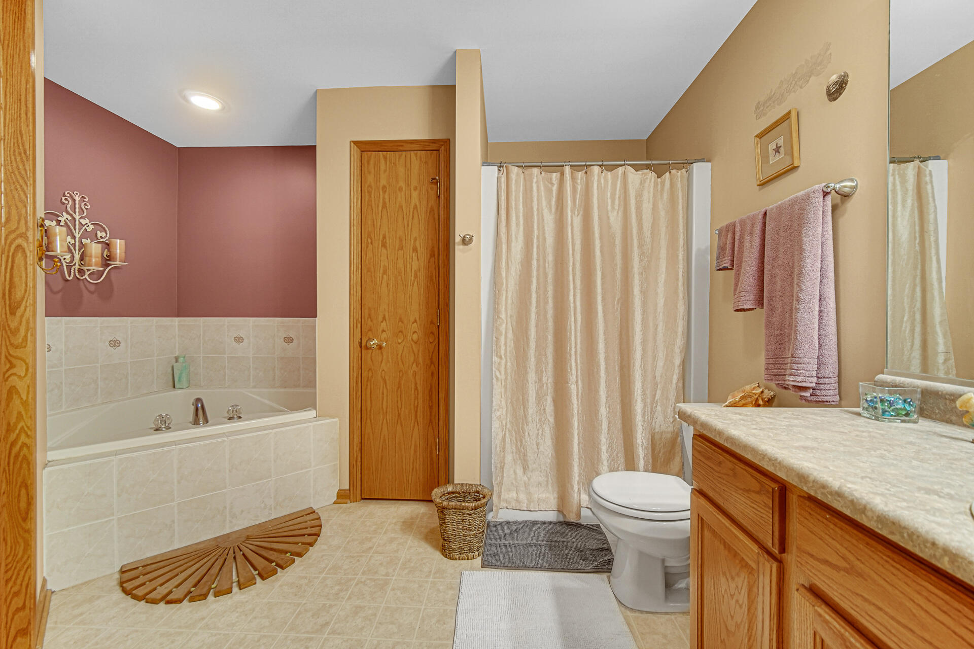 947 Oak Drive Crown Point, IN 46307 - Photo 15 of 23 a spacious bathroom with a double vanity sink a mirror and a bathtub