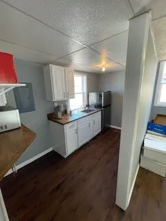 a kitchen with granite countertop a refrigerator and a stove top oven