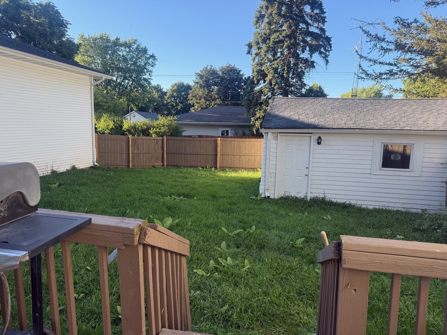 10-12 South Somonauk Road Cortland, IL 60112 - Photo 27 of 29 a view of a backyard with plants and wooden fence