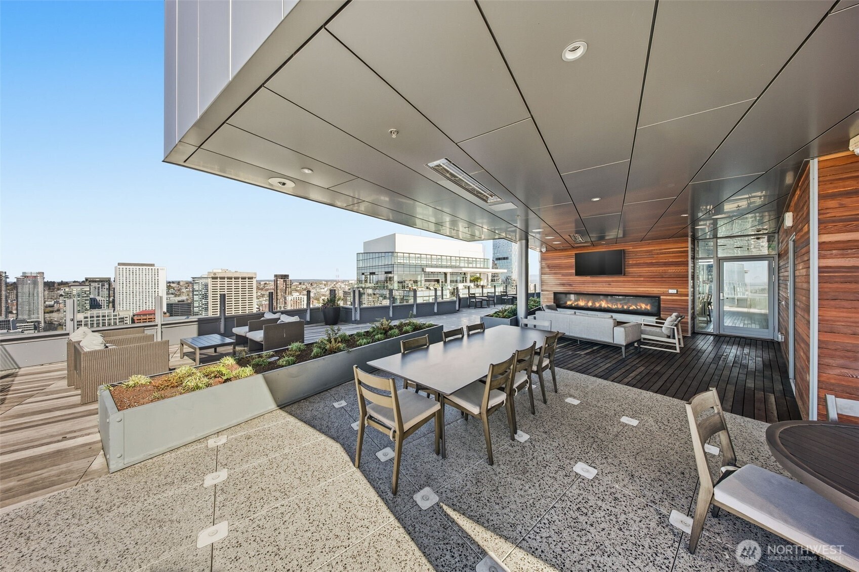121 Stewart Street, Unit 1803 Seattle, WA 98101 - Photo 18 of 28 a living room with lots of furniture and kitchen view