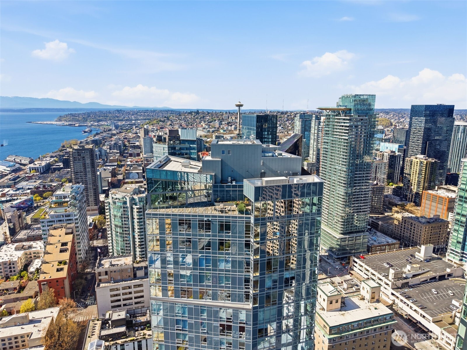 121 Stewart Street, Unit 1803 Seattle, WA 98101 - Photo 2 of 28 a city view with tall buildings