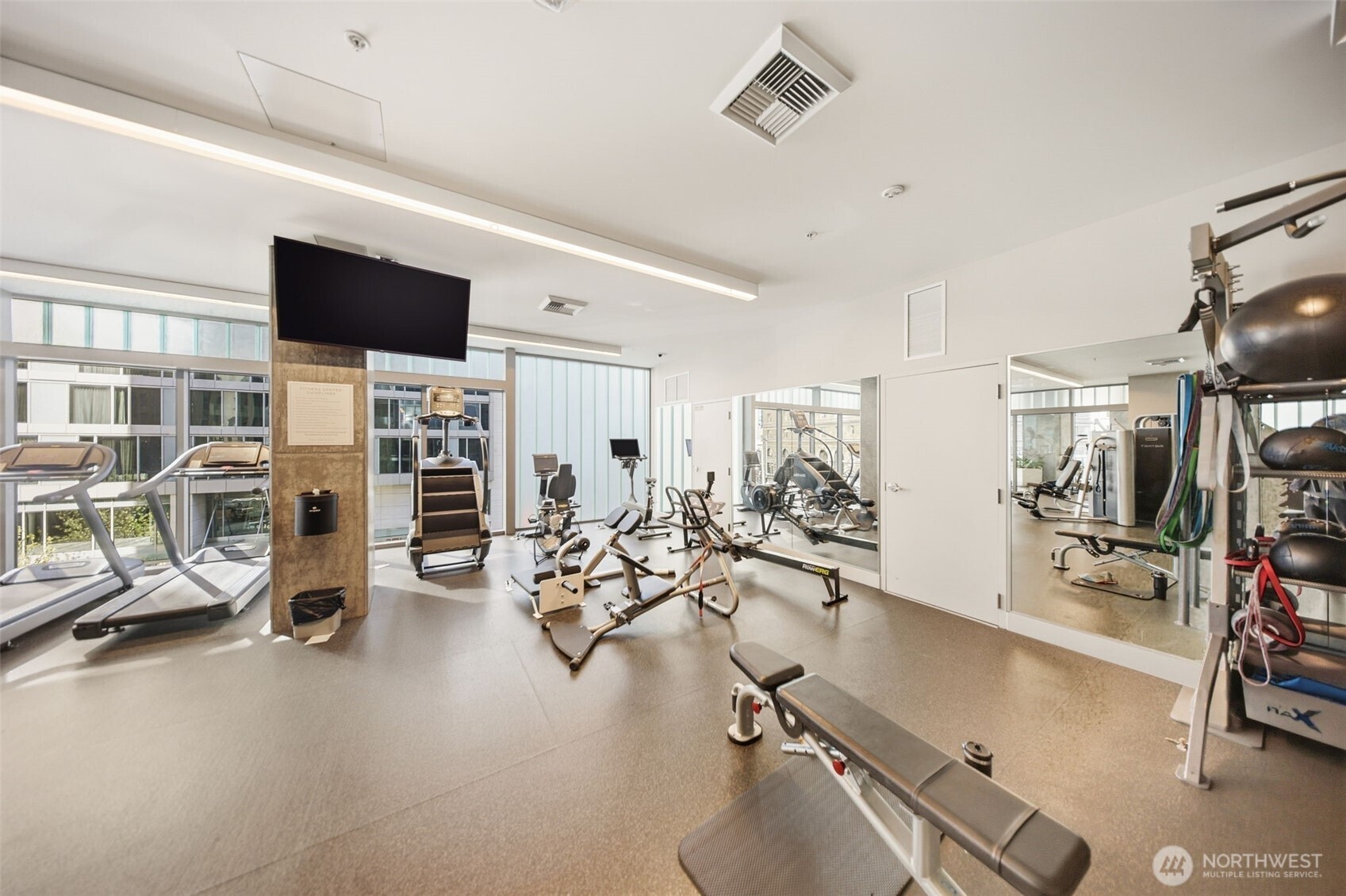 121 Stewart Street, Unit 1803 Seattle, WA 98101 - Photo 22 of 28 a view of a room with gym equipment