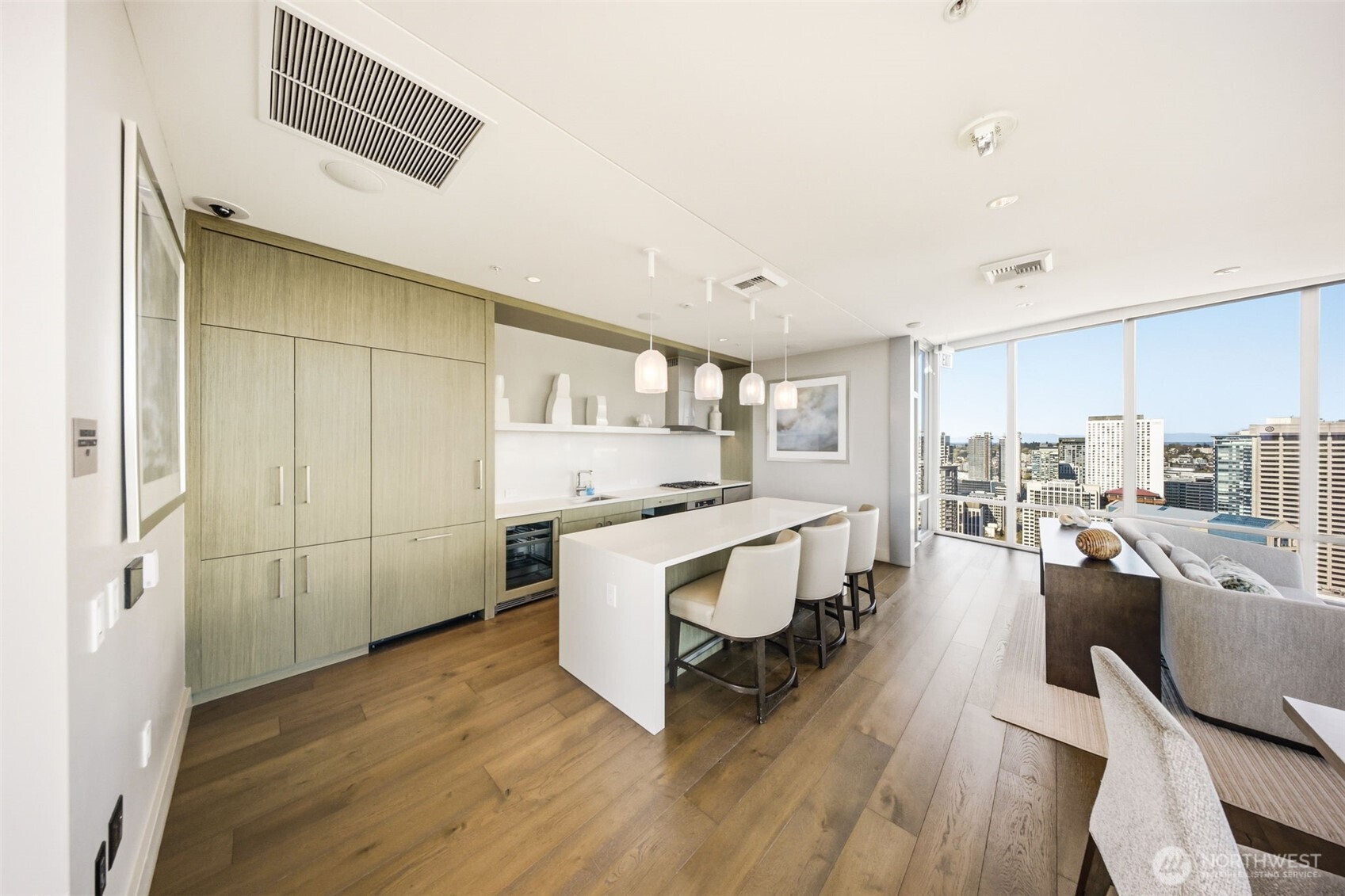 121 Stewart Street, Unit 1803 Seattle, WA 98101 - Photo 24 of 28 a living room with furniture a large window and wooden floor