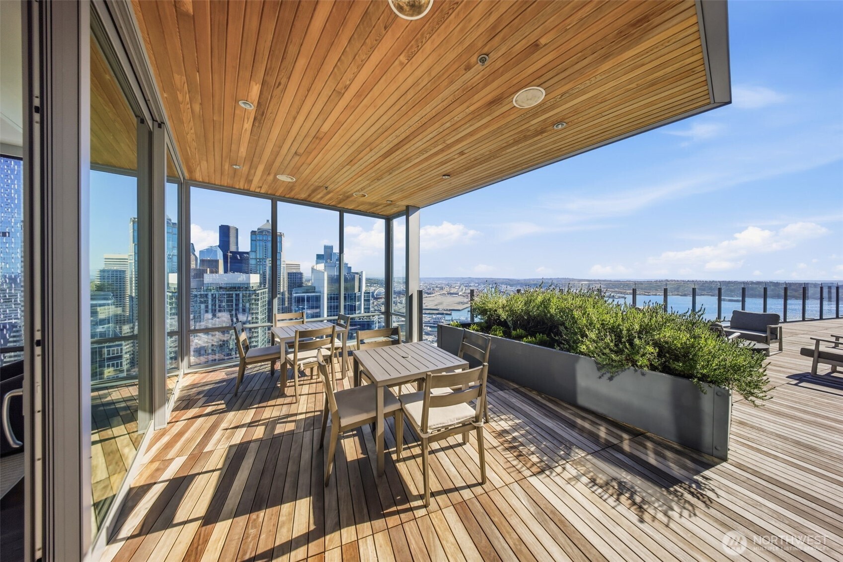 121 Stewart Street, Unit 1803 Seattle, WA 98101 - Photo 27 of 28 a view of a balcony with furniture and wooden floor