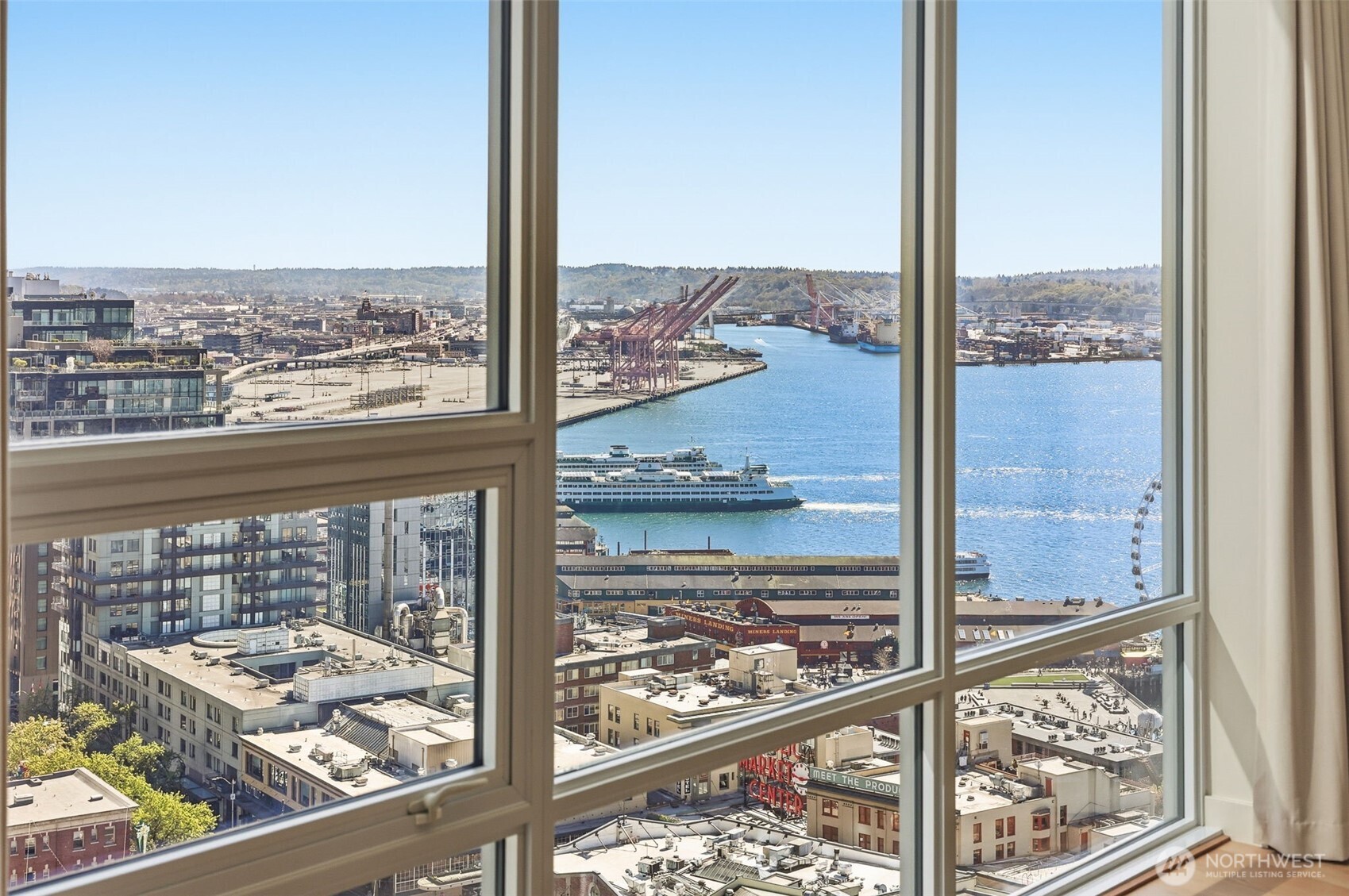 121 Stewart Street, Unit 1803 Seattle, WA 98101 - Photo 7 of 28 a view of a city from a window