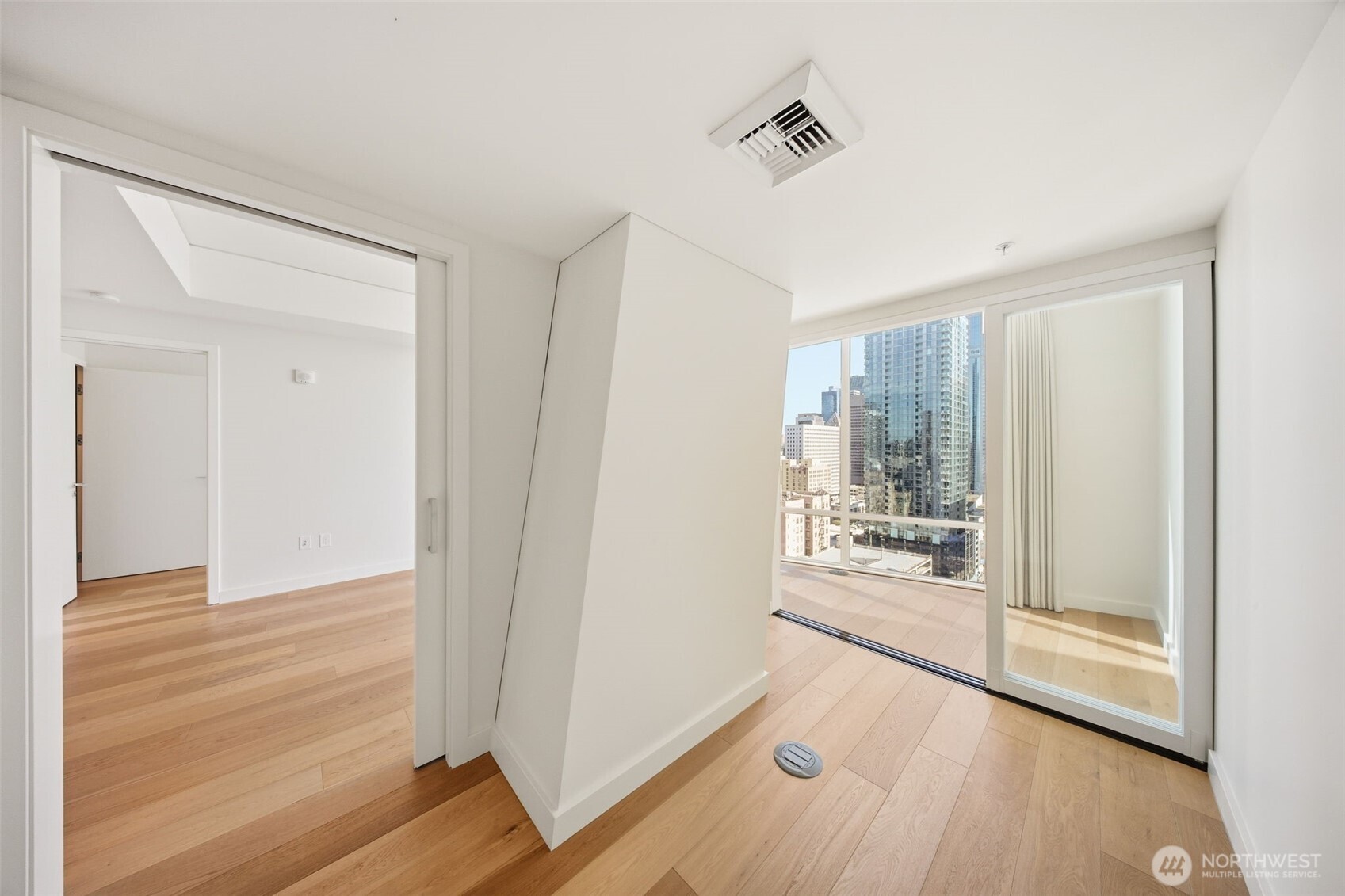 121 Stewart Street, Unit 1803 Seattle, WA 98101 - Photo 10 of 28 a view of a big room with wooden floor and windows