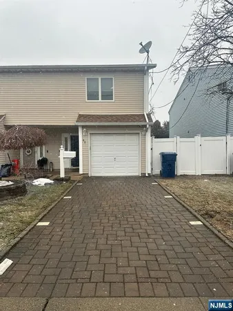 a view of a house with a yard and garage
