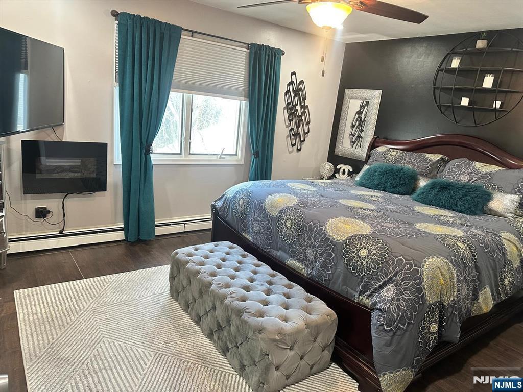 62 Frederick Street, Unit 1 Hackensack, NJ 07601 - Photo 11 of 18 a bedroom with a bed and a flat tv screen on dresser