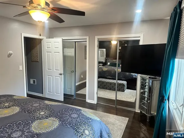 a spacious bedroom with a bed and a walk in closet