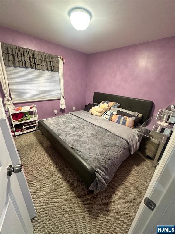 62 Frederick Street, Unit 1 Hackensack, NJ 07601 - Photo 13 of 18 a bedroom with a bed and a mirror