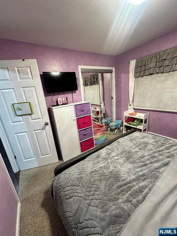 62 Frederick Street, Unit 1 Hackensack, NJ 07601 - Photo 14 of 18 a bedroom with a bed and flat screen tv