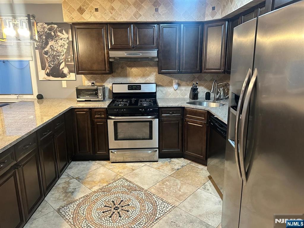 62 Frederick Street, Unit 1 Hackensack, NJ 07601 - Photo 6 of 18 a kitchen with stainless steel appliances granite countertop a stove a sink and a refrigerator