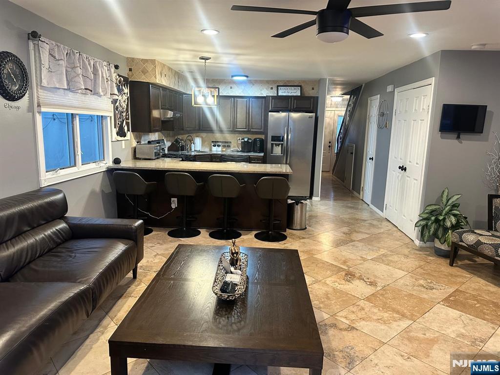 62 Frederick Street, Unit 1 Hackensack, NJ 07601 - Photo 7 of 18 a living room with stainless steel appliances kitchen island granite countertop furniture and a view of kitchen