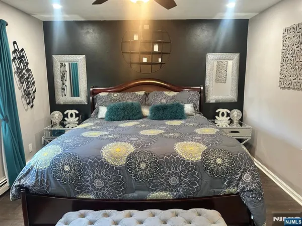 a bedroom with a bed and mirror