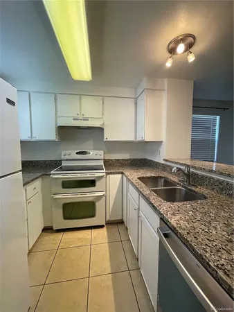 a kitchen with a stove sink and cabinets