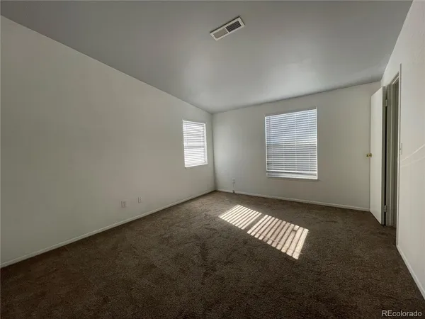 a view of an empty room with windows
