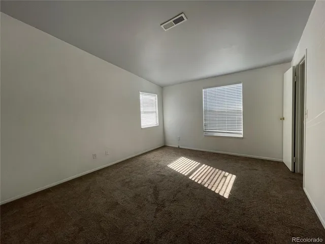 a view of an empty room with windows