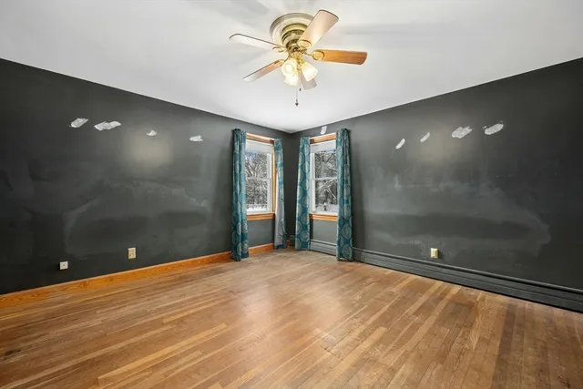a view of a room with a chandelier fan and a bathroom