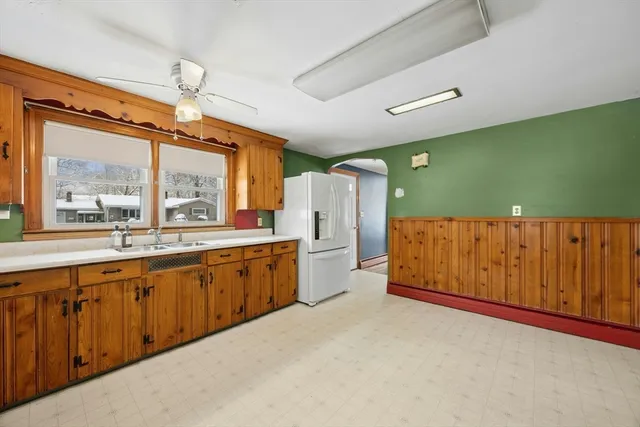 a large kitchen with stainless steel appliances a large window