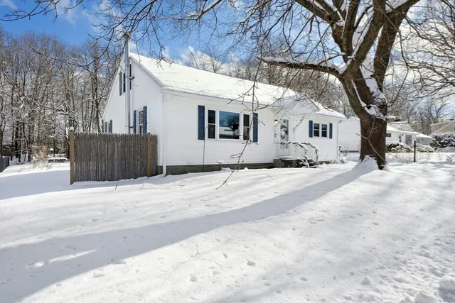 a front view of a house with snow on the road