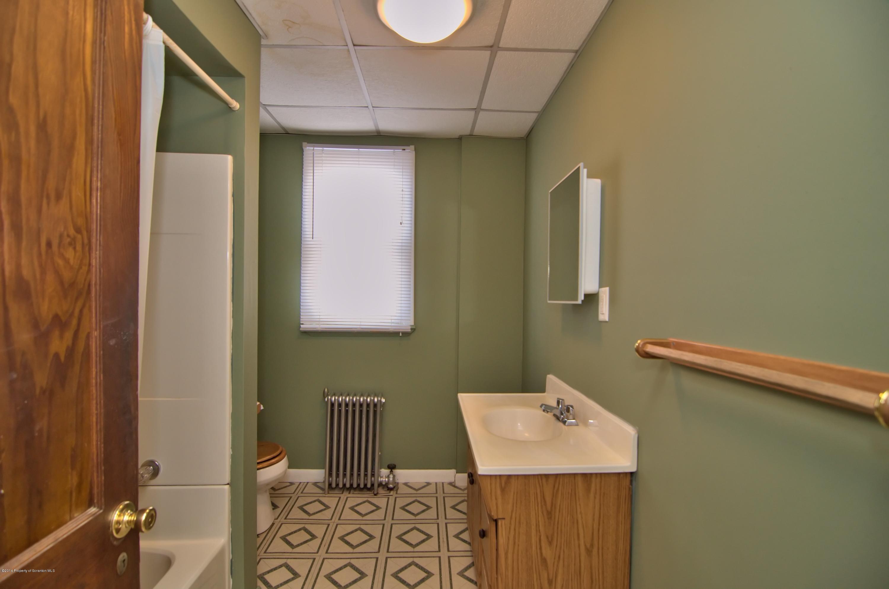 2001 Green Ridge Street Dunmore, PA 18512 - Photo 29 of 40 a bathroom with a sink toilet and mirror