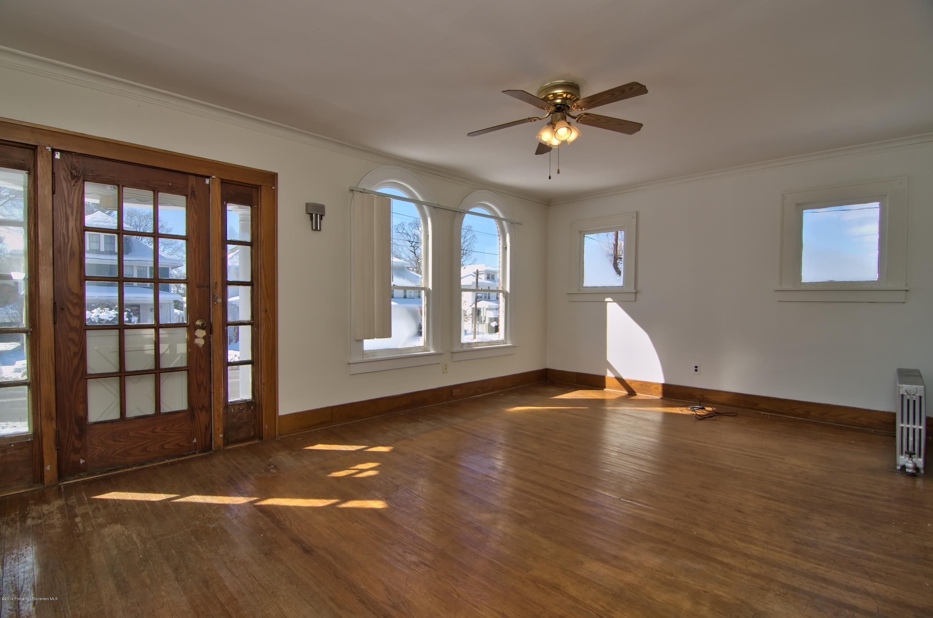 2001 Green Ridge Street Dunmore, PA 18512 - Photo 3 of 40 a view of an empty room with window and wooden floor